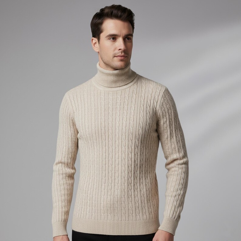 May include: A beige turtleneck sweater with a cable knit design. The sweater has a ribbed collar and cuffs. The model is wearing a black bottom. The sweater is made of a soft, warm material.