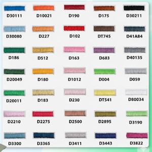 May include: A color chart of embroidery floss in various shades, including blues, greens, reds, pinks, and yellows. Each color is labeled with a unique code, such as D30111, D10021, and D190. The floss is neatly arranged.