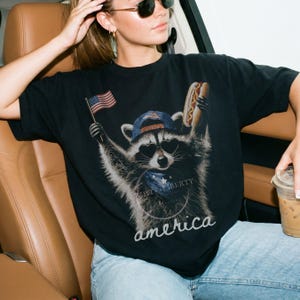 Patriotic Raccoon Hotdog T-Shirt Comfort Colors Funny Meme USA America 4th of July Tee American Flag Independence Day Humor Unisex Shirt Black