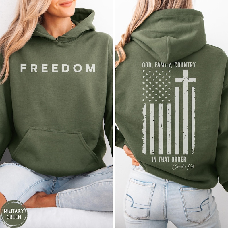 May include: Military green hoodie with the word "FREEDOM" printed in white on the front. The back features an American flag design with a cross and the text "GOD, FAMILY, COUNTRY IN THAT ORDER".