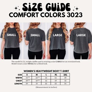 May include: Size guide for Comfort Colors 3023 heavyweight boxy t-shirts. The image shows models wearing the shirts in sizes Small and Large. A size chart provides measurements in inches for sizes S to 2XL, including width, chest, and length.