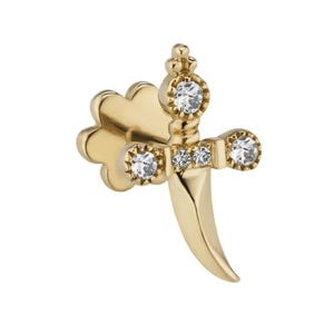 May include: A gold-colored earring in the shape of a dagger, with three clear gemstones on the hilt and one on the pommel. The blade curves downward. The earring has a post backing.