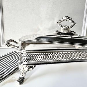 May include: A rustic wooden sign with the text "Welcome to our home" in white lettering. The sign features a distressed finish and a simple, inviting design, perfect for a front porch or entryway.