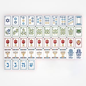 May include: A set of rectangular mahjong tiles featuring Jewish-themed illustrations. The tiles display blue Star of David symbols, green olive branches, red dreidels with Chinese characters, gold menorahs, hamsa hands, and Hebrew letters.