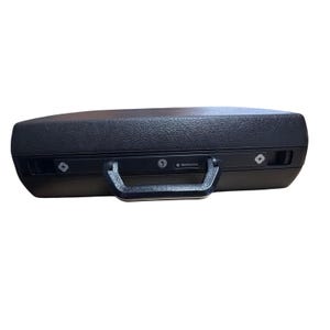 May include: A black Samsonite briefcase with a textured surface. The briefcase has a black handle and two combination locks. The Samsonite logo is visible on the front of the briefcase.