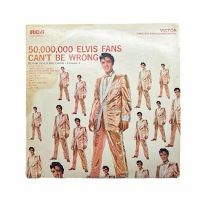 May include: Vintage vinyl record album cover for "50,000,000 Elvis Fans Can't Be Wrong." The cover features multiple images of Elvis Presley in a gold suit. The RCA Victor logo is visible, along with song titles.