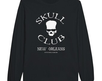 May include: Black long-sleeve shirt with a white graphic. The graphic features a skull with the text "SKULL CLUB NEW ORLEANS" and the website address. The shirt is made of a soft material.