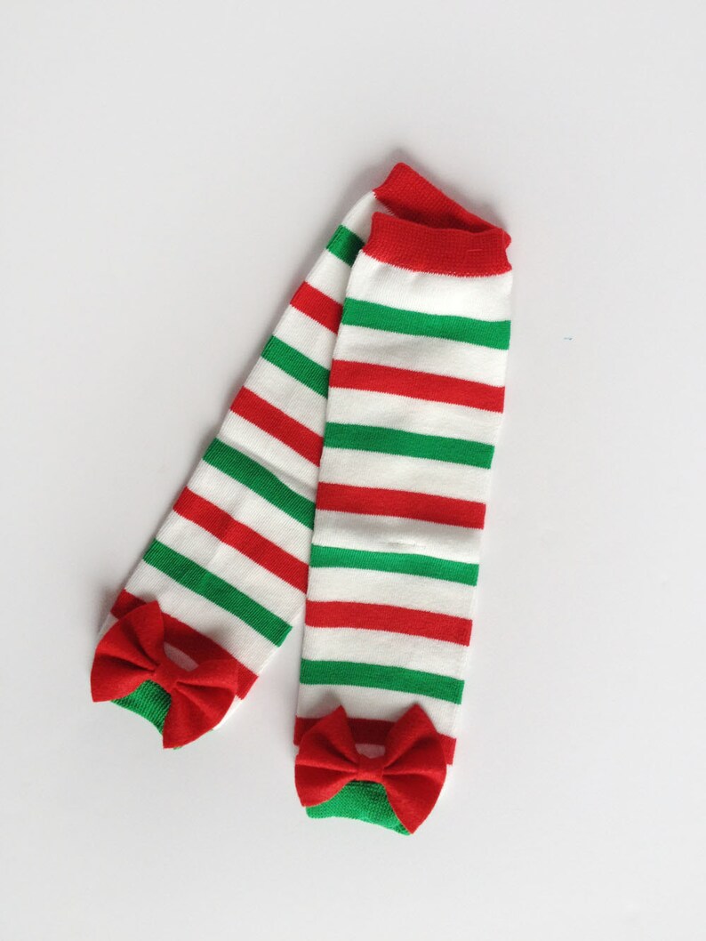 May include: A pair of red and green striped leg warmers with red bows at the bottom.