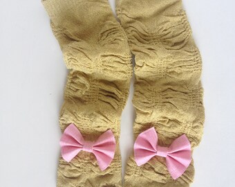 Gold sparkly leg wamers with ruffle and bows