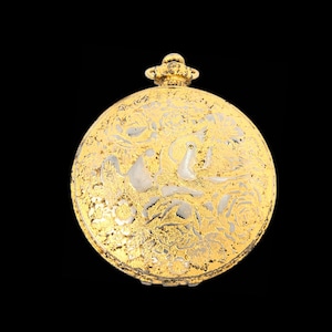 May include: A round gold-tone pocket watch case featuring an intricate engraved floral pattern across the front surface. The design includes detailed rose motifs and a small winding crown at the top center, set against a solid black background.