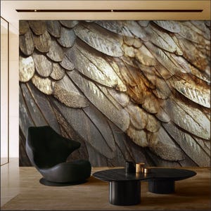 May include: A wall mural featuring a detailed, textured pattern of overlapping, metallic-toned feathers in shades of brown and gold. A black chair and a black coffee table with gold accents are in front of the mural.