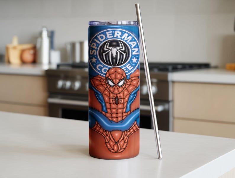 May include: A stainless steel tumbler featuring a Spider-Man design. The tumbler has a blue top with the words "Spider-Man Coffee" and a spider logo. The body of the tumbler displays Spider-Man's costume in red and blue. A silver straw is placed next to the tumbler.