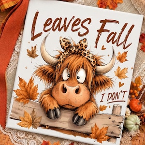 May include: A square canvas print featuring a cartoon Highland cow with a leopard print bow between its horns. The cow rests on a wooden fence surrounded by orange autumn leaves. The text reads Leaves Fall I DON'T in brown lettering.