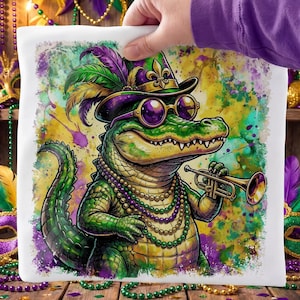 May include: A white square pillow featuring a colorful illustration of an alligator in a Mardi Gras hat and sunglasses, playing a trumpet. The alligator is green, with purple and gold accents. The background has a watercolor effect.
