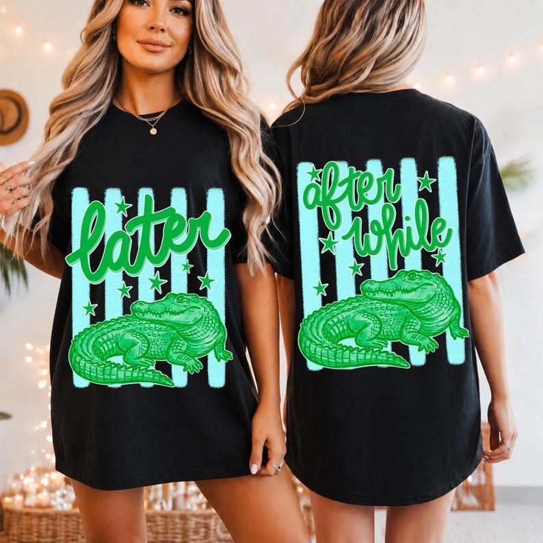 May include: Black t-shirt with a green alligator graphic. The front of the shirt has the word "later" in green script, and the back says "after while". Both sides feature vertical light blue stripes and stars.