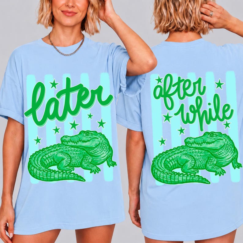 May include: Light blue t-shirts with a green alligator graphic. The front of the shirt says "later" in green script, and the back says "after while". The design includes green stars and blue stripes.