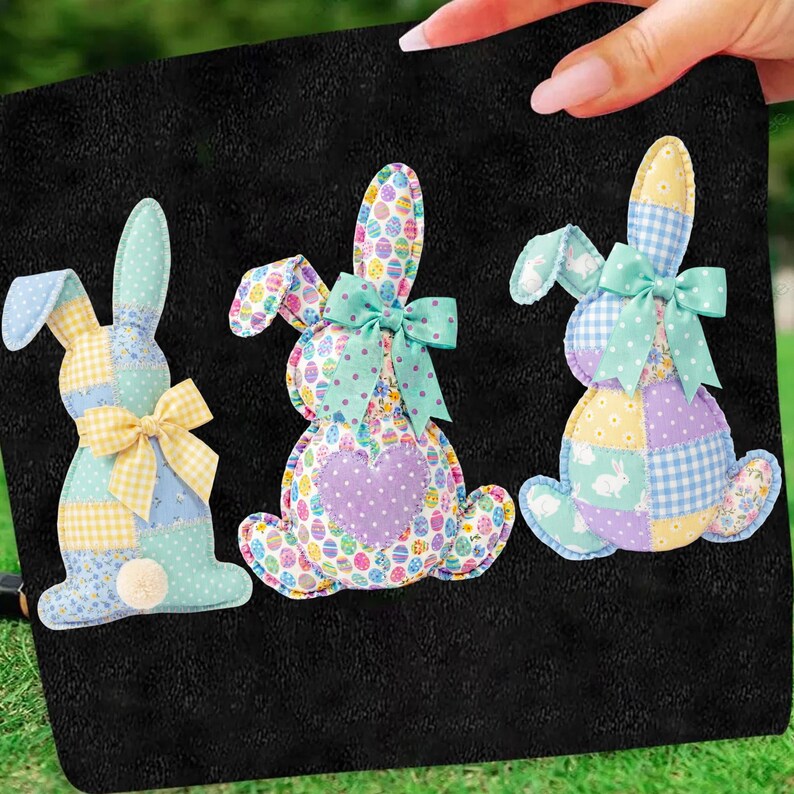 May include: Three colorful Easter bunny decorations with patchwork patterns and bows. The bunnies are made of fabric and have different patterns, including gingham, polka dots, and egg designs. Each bunny has a bow and a fluffy tail.