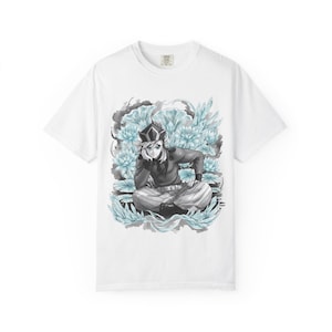 May include: White t-shirt featuring a detailed illustration of an anime character surrounded by light blue flowers. The character is depicted in a seated position, wearing a dark outfit and a decorative hat. The design is centered on the shirt.