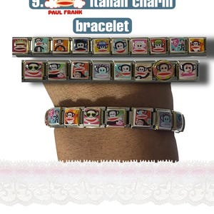 May include: Italian charm bracelet featuring colorful Paul Frank monkey designs. The bracelet is made of rectangular charms with various monkey illustrations. The text "Italian charm bracelet" is visible in the image.