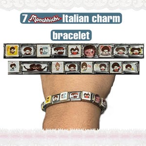 May include: A silver Italian charm bracelet featuring Monchhichi character designs. The bracelet is shown with two rows of charms and one worn on a wrist. The charms have various illustrations of the Monchhichi character.