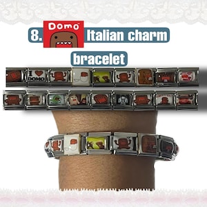 May include: Italian charm bracelet featuring Domo-kun character designs. The bracelet is made of rectangular metal links, each displaying a different Domo-kun image. The text "Italian charm bracelet" is visible in the image.