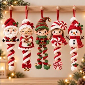 May include: Five crocheted Christmas ornaments hanging from a wooden rack. The figures include Santa Claus, Mrs. Claus, an elf, a girl with a peppermint hat, and a snowman. Each character features a long, spiraling, candy-cane-colored tail.
