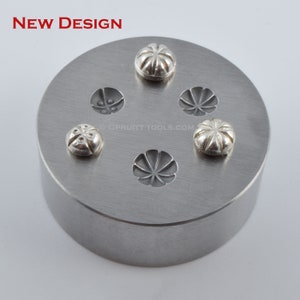 May include: A metal stamp with five different designs for creating jewelry. The stamp has a circular base and is made of silver metal. The designs are all different shapes and sizes, and they are all very intricate. The stamp is used to create jewelry by pressing it into metal.