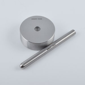 May include: A silver metal ring with a hole in the center and a silver metal rod with a rounded end. The ring and rod are labeled "C. Pruitt Tools".