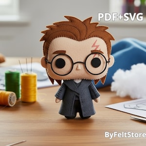 May include: A felt doll of a character with brown hair, round glasses, and a lightning bolt scar. The doll wears a grey coat and black trousers. The image includes spools of thread, needles, and the text "PDF+SVG" and "ByFeltStore".