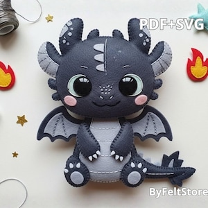 May include: A handmade felt dragon in shades of gray and black, with large, expressive eyes and small wings. The dragon is surrounded by felt stars, flames, and a star. The text "PDF+SVG" is visible.