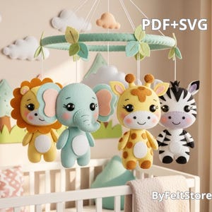 May include: A baby mobile featuring felt animal figures: a lion, elephant, giraffe, and zebra. The mobile has a green ring with leaves and clouds. The text "PDF+SVG" is visible. The mobile hangs over a white crib.