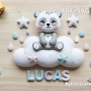 May include: A felt panda bear sits on a white cloud with star and raindrop accents. The name "LUCAS" is spelled out in pastel letters below the cloud. The image includes the text "PDF+SVG" and "ByFeltStore".