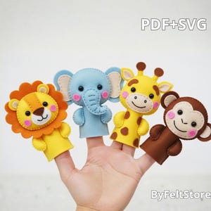Puede incluir: Una mano muestra cuatro marionetas de dedo de fieltro: un león, un elefante, una jirafa y un mono. El león tiene una melena naranja y un cuerpo amarillo. El elefante es azul, la jirafa es amarilla con manchas marrones y el mono es marrón.