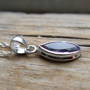 Amethyst pendant necklace: sterling silver bezel, February birthstone, dainty oval-cut stone on a delicate chain.
