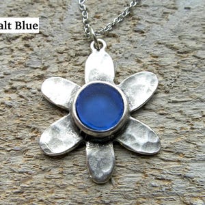 Handmade sea glass flower pendant necklace with aqua blue and other colours in a cabochon in a five-petal silver setting on a silver chain.