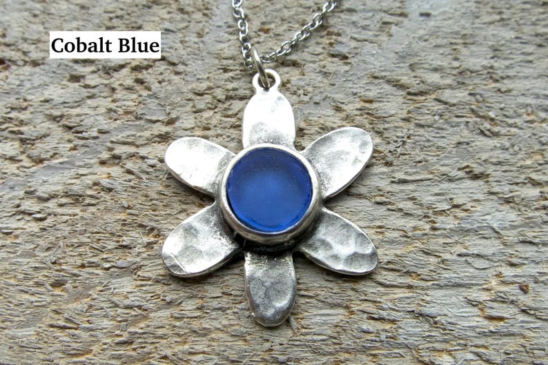 Handmade sea glass flower pendant necklace with aqua blue and other colours in a cabochon in a five-petal silver setting on a silver chain.