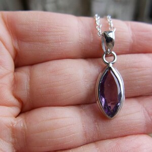 Amethyst pendant necklace: sterling silver bezel, February birthstone, dainty oval-cut stone on a delicate chain.