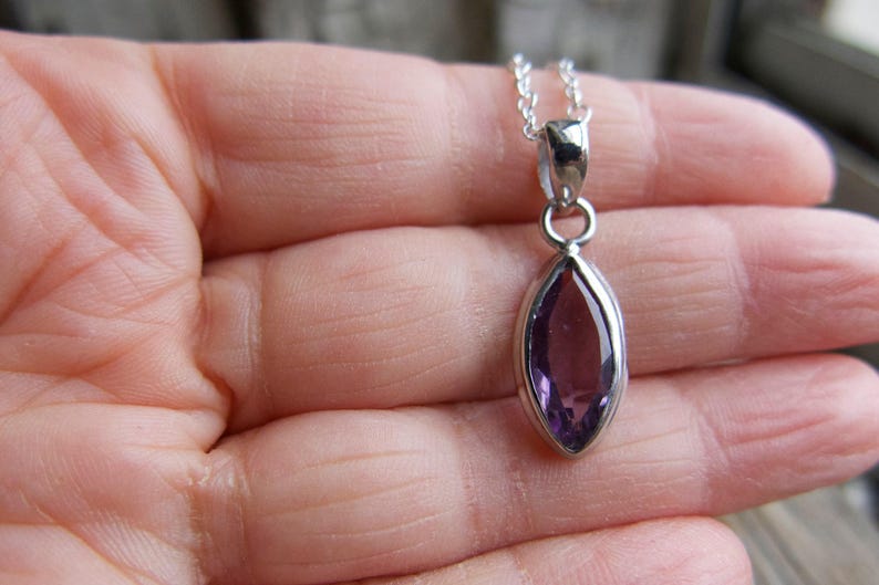 Amethyst pendant necklace: sterling silver bezel, February birthstone, dainty oval-cut stone on a delicate chain.