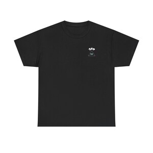 May include: Black t-shirt with a small white and teal graphic on the upper left chest. The graphic features the text "369" above a triangle with an eye inside. The shirt has a crew neck and short sleeves.