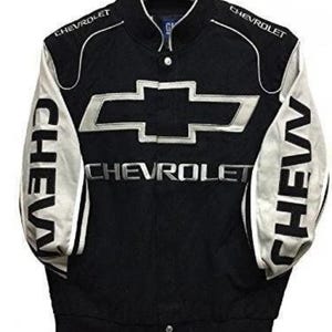May include: Black and white Chevrolet racing jacket. The jacket features the Chevrolet logo in silver on the front and the word "CHEV" on the sleeves. The word "CHEVROLET" is also displayed across the chest.