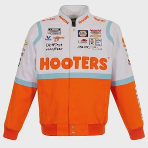May include: White, orange, and light blue racing jacket with the word "HOOTERS" in large orange letters across the chest. The jacket has multiple sponsor logos and the words "NASCAR CUP SERIES".