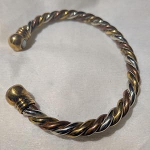 2005 Avon Tri-tone  twist magnetic bracelet Silver, Copper, and Brass. Collector's item