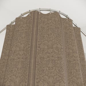 May include: A brown shower curtain with a repeating floral pattern and vertical stripes. The curtain hangs from a curved, silver-colored shower rod. The fabric has a textured appearance.