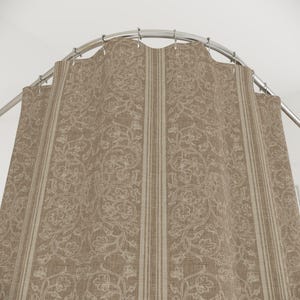 May include: A beige shower curtain with a floral pattern and vertical stripes. The curtain hangs from a curved, silver-colored shower rod. The floral design is in a lighter beige color, creating a subtle contrast against the darker beige background.