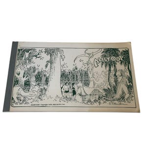 May include: Vintage "Alley Oop" comic book. The black and white illustration depicts a jungle scene with dinosaurs, palm trees, and characters. The comic book has a grey spine and the title "Alley Oop" is visible.