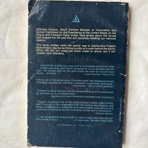 May include: Vintage paperback book titled "Soul on Ice" by Eldridge Cleaver. The cover is dark blue with white text and a triangular logo. The back cover features quotes and biographical information.