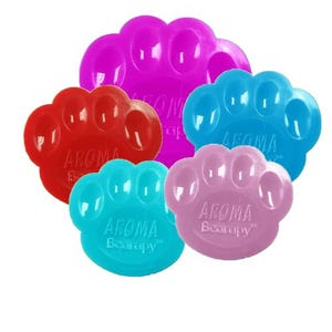 May include: A collection of colorful, paw-shaped aromatherapy diffusers. The diffusers are in shades of red, blue, pink, and purple. Each diffuser has the text "AROMA Bearapy" printed on it.