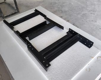 May include: A black metal frame structure featuring two parallel rectangular side rails connected by three perpendicular crossbars. The frame has multiple pre-drilled circular holes along the edges for mounting purposes and a smooth, matte finish.