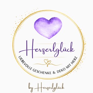 May include: A logo featuring a watercolor-style purple heart above the word "Herzerlgl&uuml;ck" in a script font. The text "LIEBEVOLLE GESCHENKE & DEKO MIT HERZ" is in a circular arrangement around the logo, with "by Herzerlgl&uuml;ck" below.
