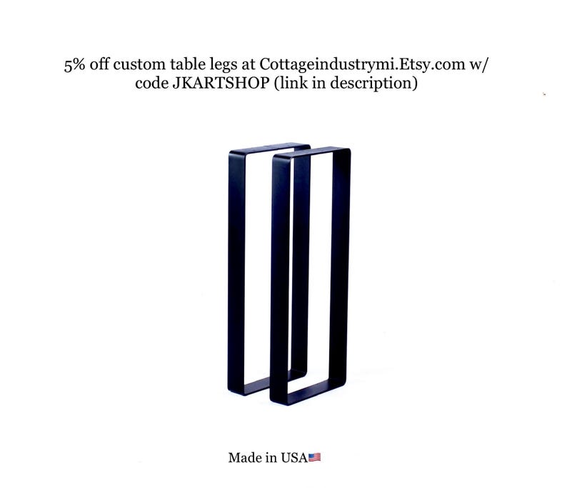 May include: Two black metal table legs, each with a rectangular shape, are shown against a white background. The legs are made in the USA.